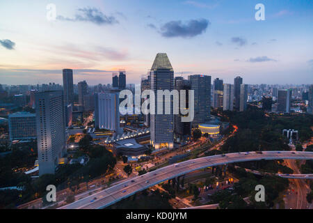 Elevated cityscape with highway and skyscrapers at dusk, Singapore, South East Asia Stock Photo