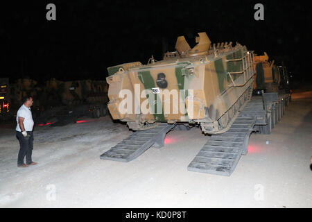 (171008) -- HATAY (TURKEY), Oct. 8, 2017 (Xinhua) -- Photo taken on Oct. 8, 2017 shows Turkish armored military vehicles gathering near the Syria-Turkish border in Reyhanli, a town in Turkey's southern Hatay province. The Turkish Armed Forces on Sunday shelled targets of extremist group in Syria's Idlib, a day after Ankara announced the start of a military operation there, private broadcaster NTV has reported. (Xinhua) Stock Photo