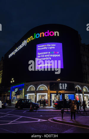 London, England, UK. 08th Oct, 2017. Piccadilly Lights - after nine-months of darkness, London's most prominent ad board is illuminated again, after a high tech refurbishment, as part of a relaunch designed to raise money for the charity Bernardo's. Credit: Benjamin John/ Alamy Live News Stock Photo