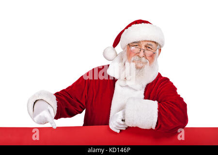 Santa Claus  leaning on big red banner and pointing in it, isolated on white background Stock Photo