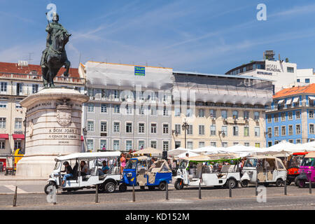Lisbon, Portugal - August 12, 2017: Tuk Tuk taxi cabs of Lisbon stand on a city square with tourists as a passengers. Piaggio Ape three-wheeled light  Stock Photo