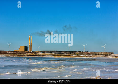 View of Lingan coal-fired Generating Station and wind turbines from Dominion Beach Provincial Park, Cape Breton , Nova Scotia, Canada Stock Photo