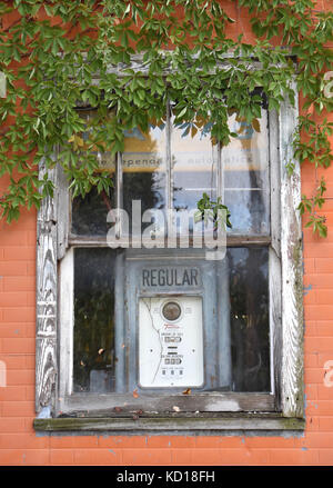 Antique gasoline pump in the window of an Antique shop in Cottonwood Falls, Kansas, USA Stock Photo