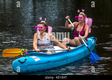 Girls in butterfly mask canoeing river Otava, Summer vacation, Czech Republic young women Czech Republic girls Stock Photo