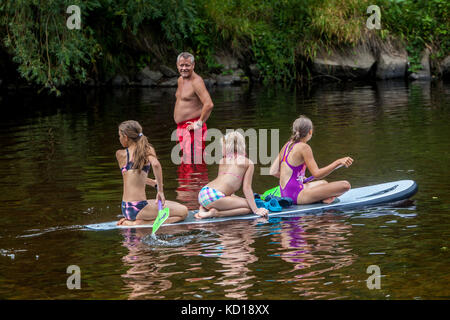 Three girls, paddleboarding,  Otava river, Vacations in summer, zech Republic girls Stock Photo