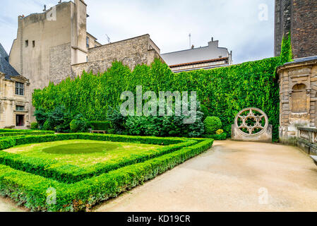 Beautiful garden within the Hôtel de Sully. The Hôtel de Sully is a Louis XIII style private mansion within the Marais area of Paris. Stock Photo