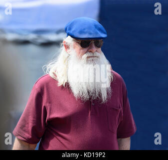 Portrait of an elderly man wearing a beret, sunglasses and a long white beard Stock Photo