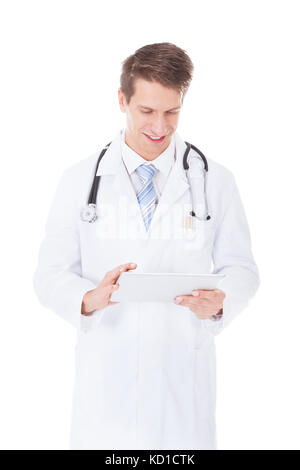 Portrait Of A Young Male Doctor Using Digital Tablet Over White Background Stock Photo
