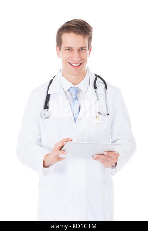 Portrait Of A Young Male Doctor Using Digital Tablet Over White Background Stock Photo