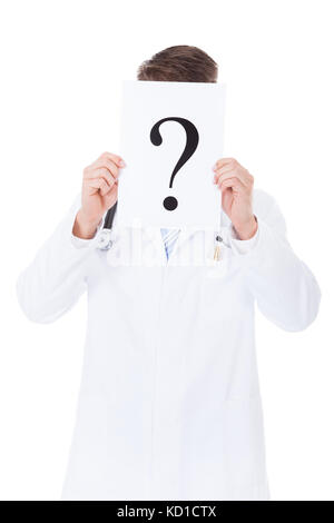 Close-up Of Doctor Holding Question Mark Sign In Front Of Face Stock Photo