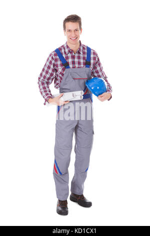 Portrait Of Young Male Architect Holding Blueprints And Hardhat Stock Photo