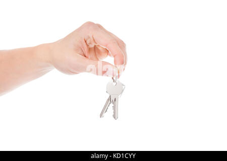 Close-up Of Person Holding Keys Over White Background Stock Photo
