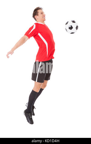 Professional soccer player kicking ball. Isolated on white Stock Photo