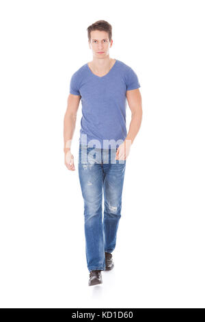 Portrait Of Young Man Walking Over White Background Stock Photo