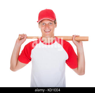 Portrait Of Player Swinging With Baseball Bat Over White Background Stock Photo