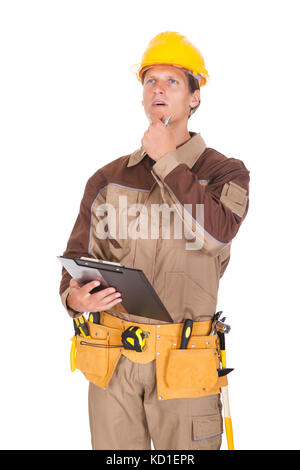 Happy Young Mechanic In Protective Workwear Writing On Clipboard Stock Photo