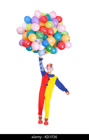 Portrait Of A Happy Clown With Multi Colored Balloons On White Background Stock Photo