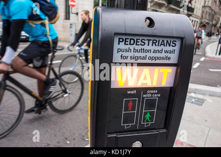 Wait sign illuminated on pedestrian crossing for a cycle lane, City of London, UK Stock Photo