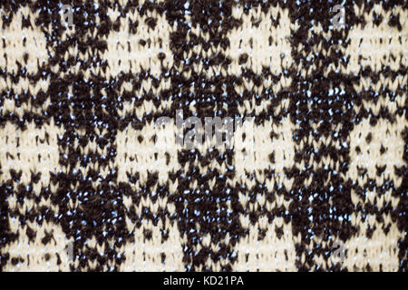 Black and white knitted texture in a cage. Stock Photo