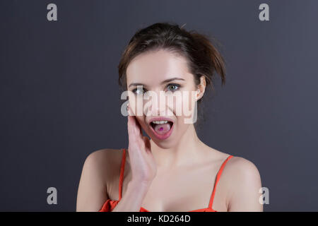 SUrprised young woman hand touching face mouth open Stock Photo