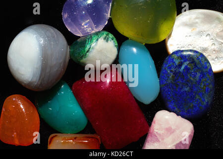 Group of multi-colored semi-precious stones on black close-up Stock Photo