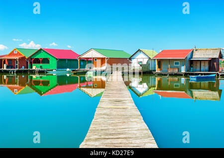 Old colorful fishing huts on a lake Stock Photo