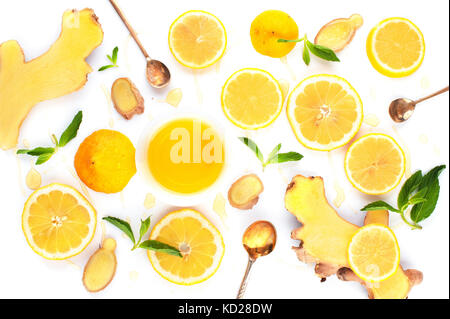 Ingredients for vitamin winter drink - cut ginger with slices of lemons and mint, honeyed Stock Photo