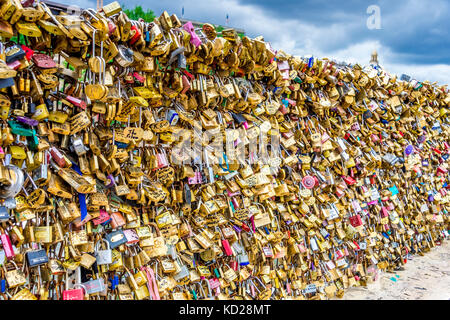 Love locks on a bridge on the  Île de la Cité in Paris. A love lock is a padlock that sweethearts lock to a bridge, fence, gate, or monument. Stock Photo