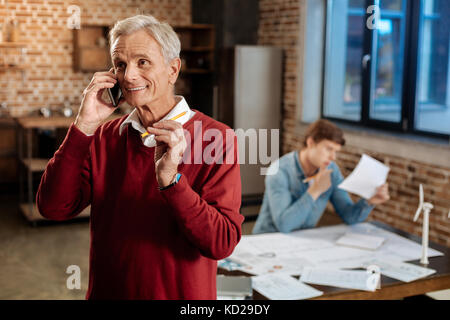 Joyful senior man talking on the phone Stock Photo