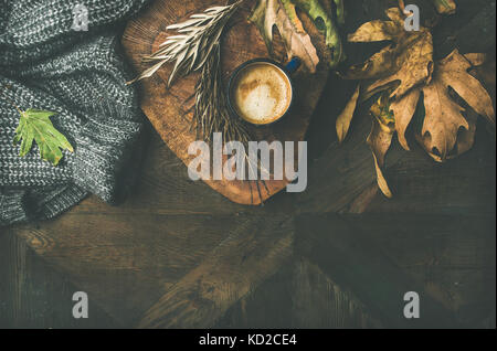 Autumn morning coffee concept with leaves and jamper Stock Photo