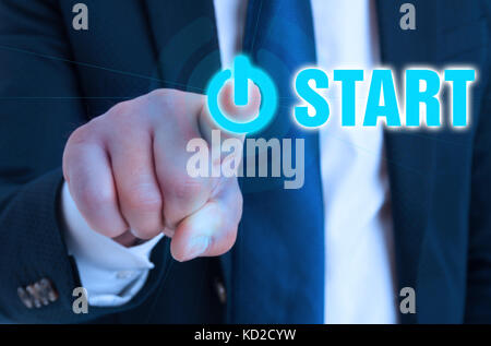 Closeup hand of entrepreneur pointing on start button in close-up view Stock Photo