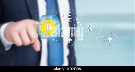 Bitcoin button touched bu executive manager on virtual interface displaying the payment system Stock Photo