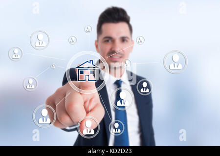 Businessman presses smart home icon and contacts connected all together Stock Photo