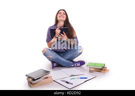 Cheerful student girl with books laughing out loud after reading something funny Stock Photo