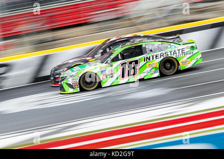 Charlotte, NC, USA. 8th Oct, 2017. Monster Energy Series driver Kyle Busch (18) passes Clint Bowyer (14) as they cross the start finish during stage one of the Bank of America 500 at Charlotte Motor Speedway in Charlotte, NC. (Scott Kinser/Cal Sport Media) Credit: csm/Alamy Live News Stock Photo