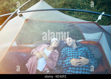 Couple lying in tent, elevated view Stock Photo