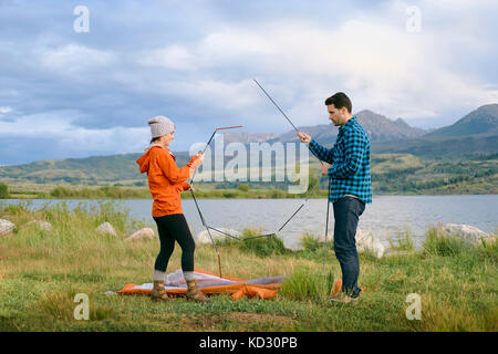 Couple in rural setting, putting up tent, Heeney, Colorado, United States Stock Photo