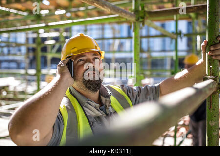Construction worker using mobile phone Stock Photo