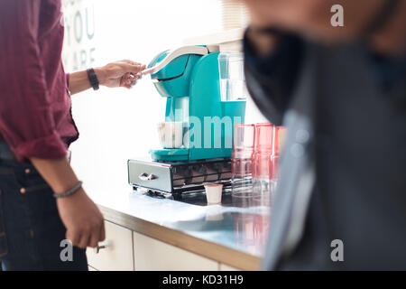 Cropped shot of businessman using coffee machine Stock Photo