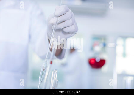 Laboratory worker doing experiment in lab, close-up Stock Photo