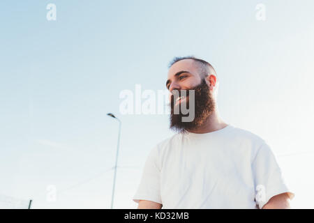 Portrait of bearded man looking away smiling Stock Photo