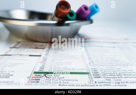 Bloodwork requisition form and vials of blood samples in kidney dish Stock Photo