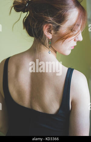 Rear view portrait of young woman looking over her shoulder Stock Photo