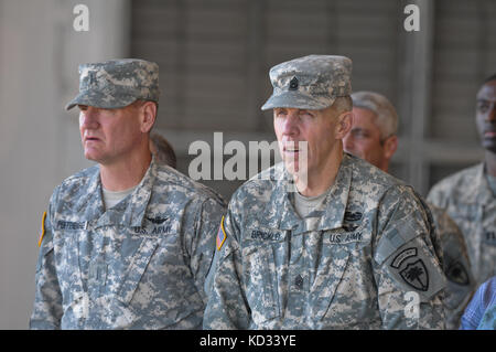 S.C. Army National Guard Soldiers, Chief Warrant Officer 5 Kent Puffenbarger, the state command chief, and Command Sgt.  Maj. Robert Brickley, state command sergeant major, observe the change of command ceremony at the Army Aviation flight facility at McEntire Joint National Guard Base, Eastover, S.C. during the 1-151st Attack Reconnaissance Battalion, S.C. Army National Guard change of command ceremony held Feb. 8. 2015, when  Lt.  Col. James R. Fidler, the outgoing commander, passed the colors to Maj. (P) John W. McElveen, the incoming commander. The purpose of the change of command ceremony Stock Photo