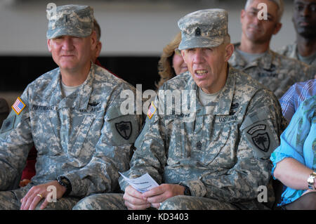 U.S. Army National Guard Soldiers, Chief Warrant Officer 5 Kent Puffenbarger, the state command chief, and Command Sgt.  Maj. Robert Brickley, state command sergeant major, observe the change of command ceremony at the Army Aviation flight facility at McEntire Joint National Guard Base, Eastover, S.C. during the 1-151st Attack Reconnaissance Battalion, S.C. Army National Guard change of command ceremony held Feb. 8. 2015, when  Lt.  Col. James R. Fidler, the outgoing commander, passed the colors to Maj. (P) John W. McElveen, the incoming commander. The purpose of the change of command ceremony Stock Photo