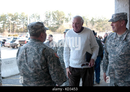 Civilian Aid to the Secretary of the Army, Bill Dukes, talks U.S. Soldiers, as they wait for members of  the South Carolina Army National Guard’s 2-263rd Air Defense Artillery Battalion, to return home to Anderson, S.C., after an eleven month rotation to Washington D.C., Feb. 11, 2015. The 2-263rd ADA has deployed as part of the National Capital Region’ s Integrated Air Defense mission on a rotational basis since the attacks on 9/11. (U.S. Army National Guard photo by Staff Sgt. Roberto Di Giovine/Released) Stock Photo