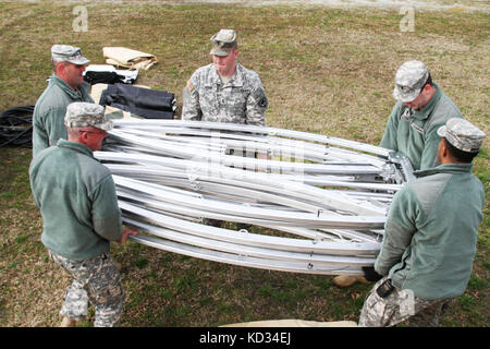U.S. Army Soldiers from the 710th Explosive Hazardous Coordination Cell, S.C National Guard, unpack the aluminum frame for a California Medium Shelter System March 6, 2015, at the Choppee Complex, in Georgetown, S.C., in preparation for Vigilant Guard 2015. The shelter can be used as offices or living quarters for Soldiers deployed to a variety of environments. Vigilant Guard is a series of federally funded disaster-response drills conducted by National Guard units working with federal, state and local emergency management agencies and first responders. (U.S. Army National Guard Photo by Sgt.  Stock Photo