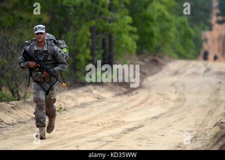 U.S. Army Sgt. Anthony Calvi, A. Co. 1-124th Infantry, Indiana Army National Guard, demonstrates his strength and endurance while completing the six-mile ruck march with a full combat load on Fort Jackson during the Region 3 Best Warrior Competition at the McCrady Training Center, Eastover, S.C., April 30, 2013. Each of the 10 states and territories in Region 3 have one Soldier and one noncommissioned officer competing in the four day event which will test their Soldiering skills, April 29 to May 2. The first-place winners in the NCO and enlisted Soldiers categories will advance to the Nationa Stock Photo