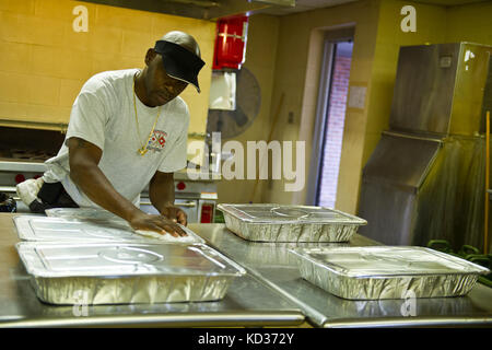 Retired South Carolina Army Guardsman Bernard Sherman provides dinner for guardsmen staying at the Georgetown, S.C., armory during the flood response and recovery, the meal was generously donated by a local business, Oct. 9, 2015.  The South Carolina National Guard has been activated to support state and county emergency management agencies and local first responders as historic flooding impacts counties statewide. Currently, more than 2,900 South Carolina National Guard members have been activated in response to the floods. (U.S. Air National Guard photo by Tech. Sgt. Jorge Intriago/Released) Stock Photo