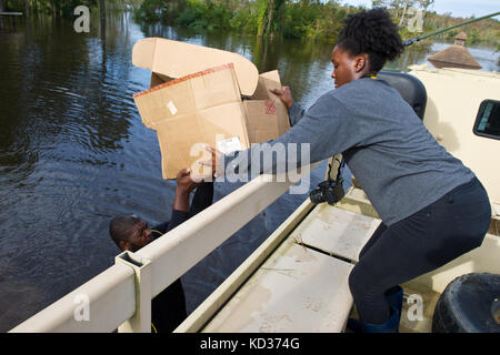 NFL player Clifton Geathers with the Pittsburgh Steelers retrieves any possessions not destroyed by the flood at his family home in Brown's Ferry near Georgetown, South Carolina, Oct. 10, 2015. The South Carolina National Guard has been activated to support state and county emergency management agencies and local first responders as historic flooding impacts counties statewide. Currently, more than 3,000 South Carolina National Guard members have been activated in response to the floods. (U.S. Air National Guard photo by Tech. Sgt. Jorge Intriago/Released) Stock Photo